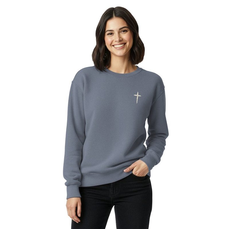 Woman wearing a blue-gray crewneck sweatshirt with a small cross on the chest; the back reads God's Got My Back